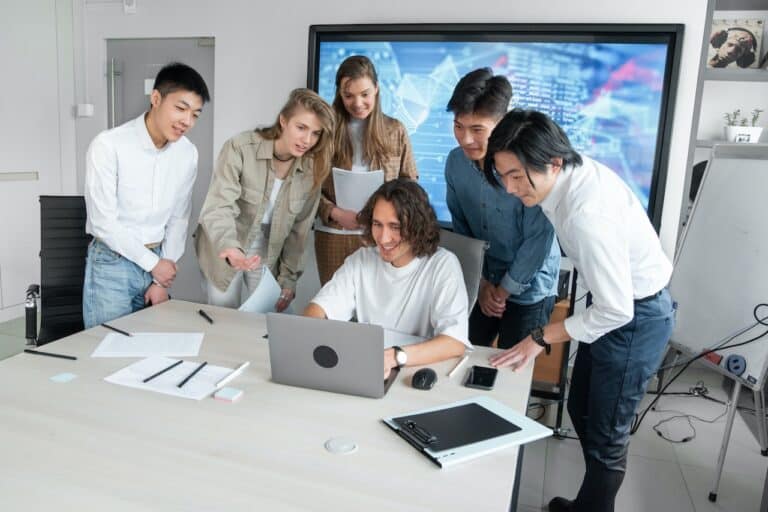 people looking at laptop